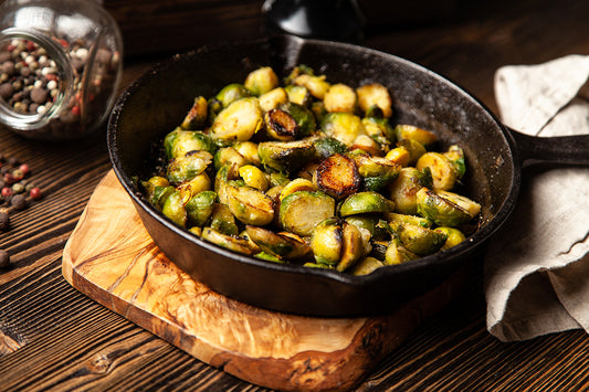 Brussel sprouts cooked with bacon grease in a cast iron skillet.